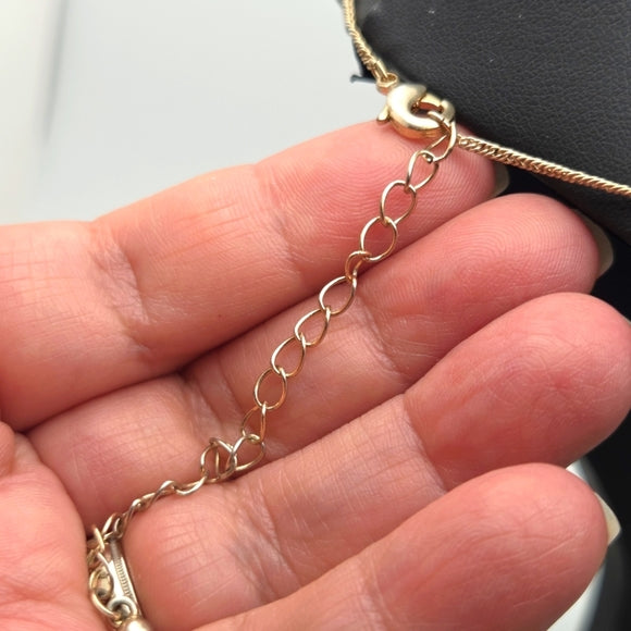 Delicate gold star doble strand necklace featuring a 1.3cm star pendant